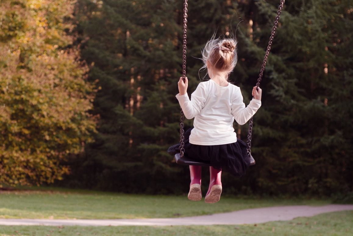 girl swinging in park
